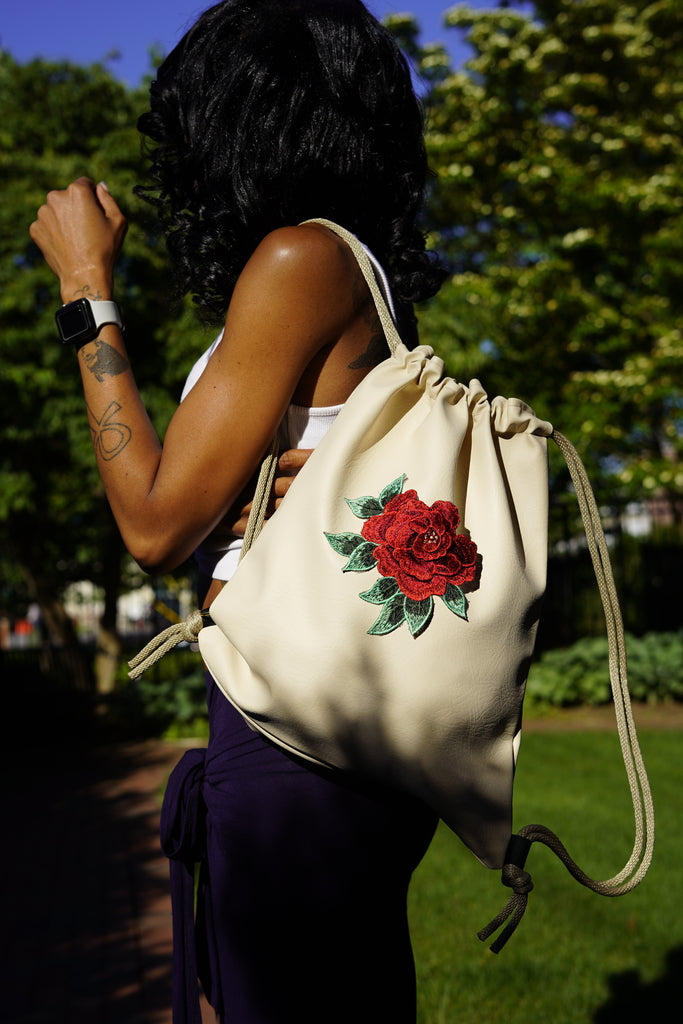 Niclor model carrying the Cream Faux  Drawstring Backpack. Niclor is an online luxury drawstring bags store offering a wide variety of custom bags at affordable prices. 